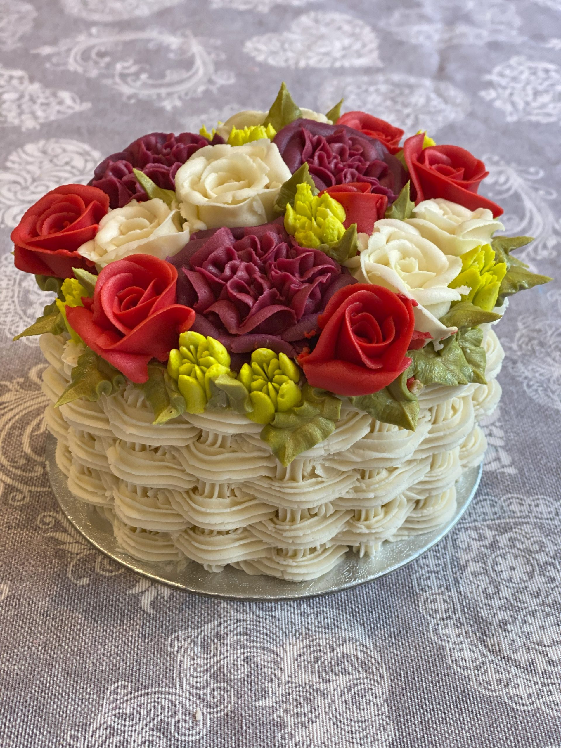 A floral bento cake with basketweave sides