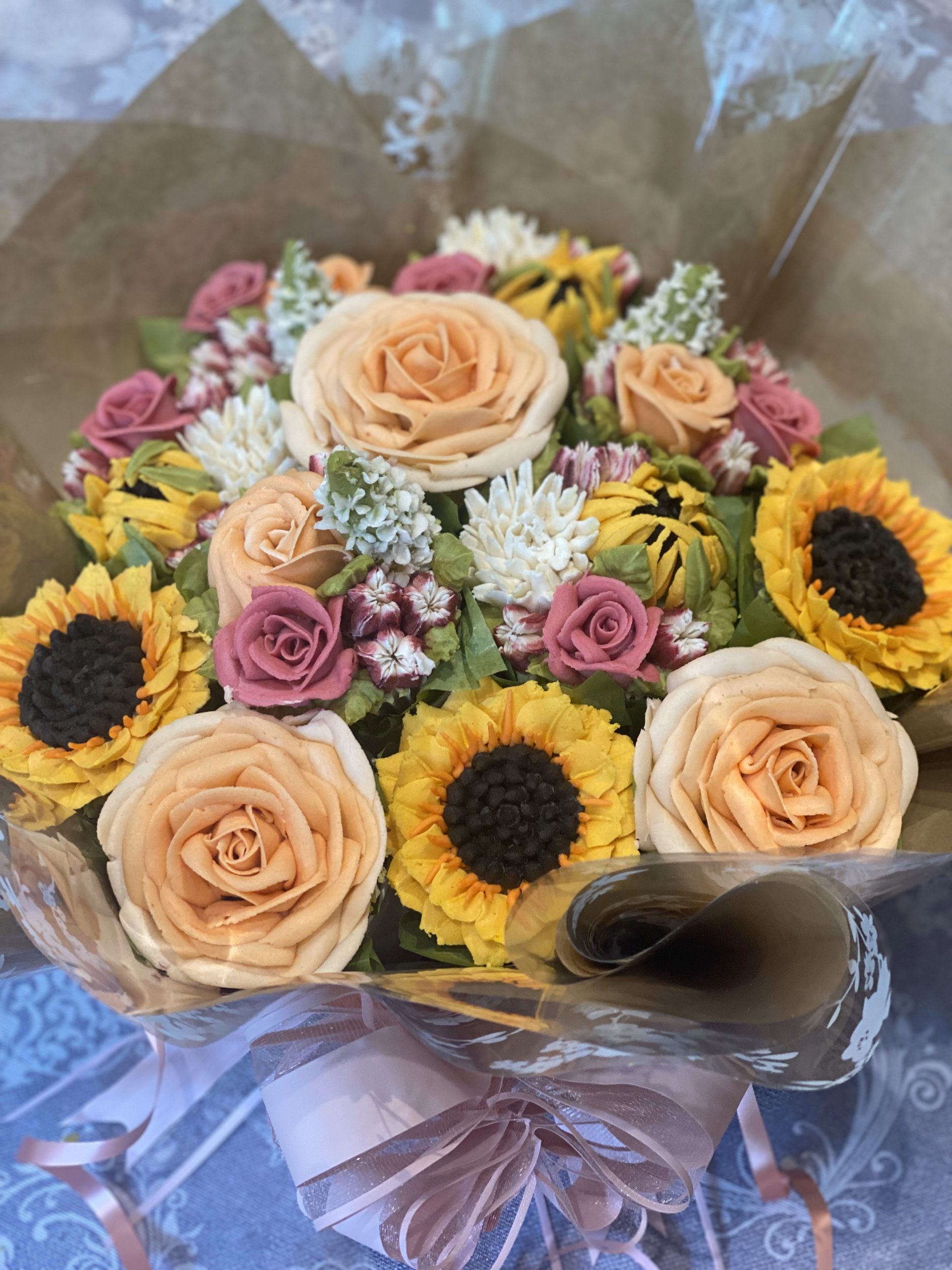 A 12 cupcake bouquet with sunflowers